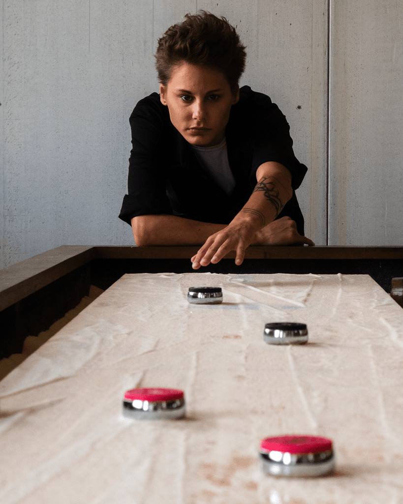 Girl playing shuffleboard